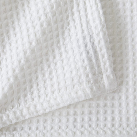 Brielle blanket on a couch illustrating all‑season comfort and style