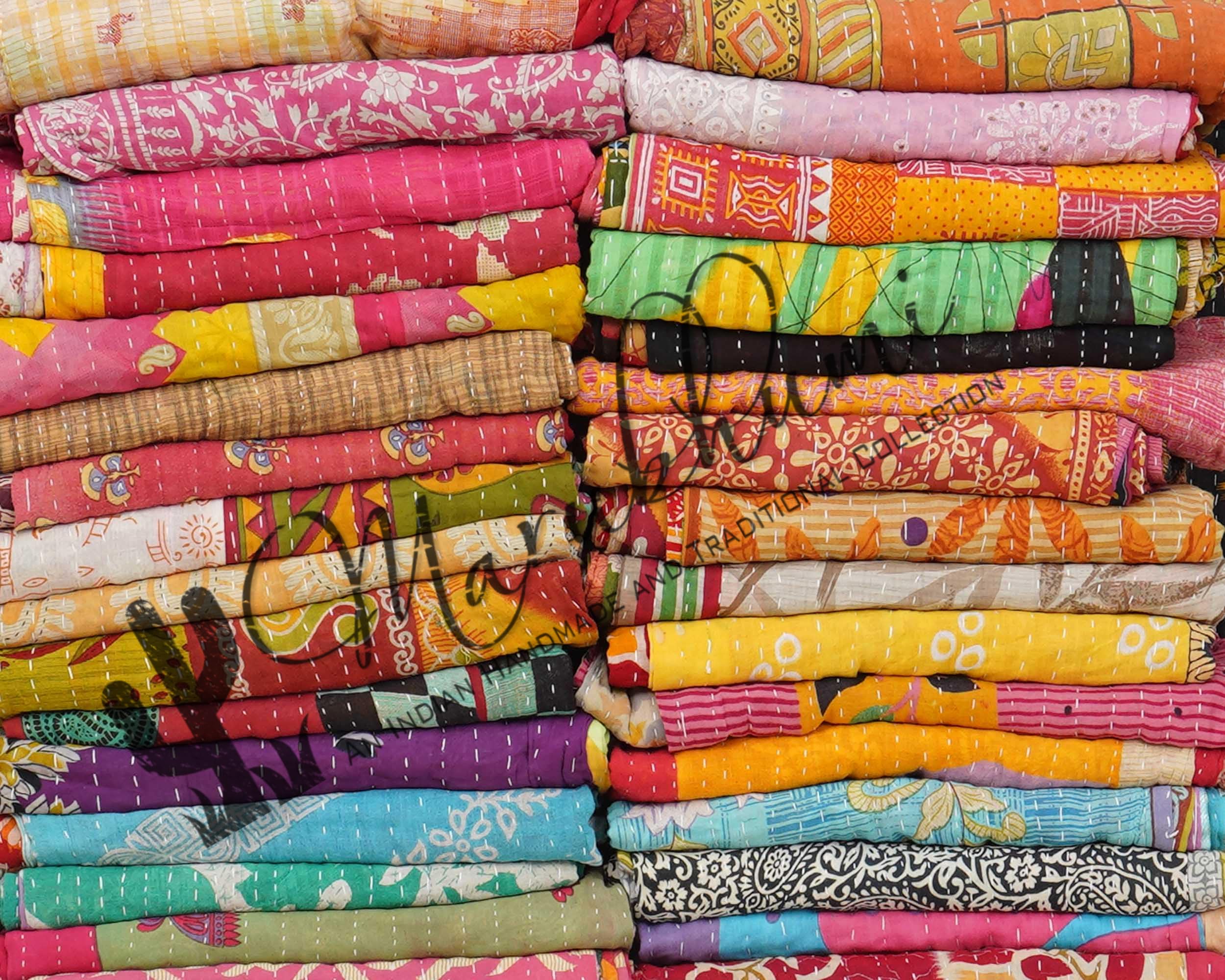 Marubhumi Kantha quilt old sari patchwork laid on a sofa.