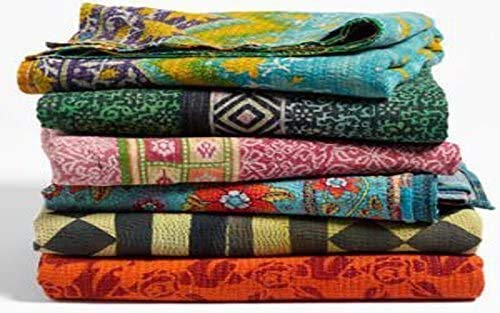 Marubhumi Kantha quilts bed throw draped to enhance living room ambiance.