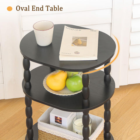 MaxSmeo living room setup with black oval end table and decor.