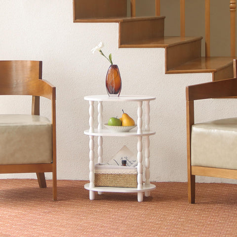 MaxSmeo oval end table with 3-tier shelves offering organized storage beside seating.