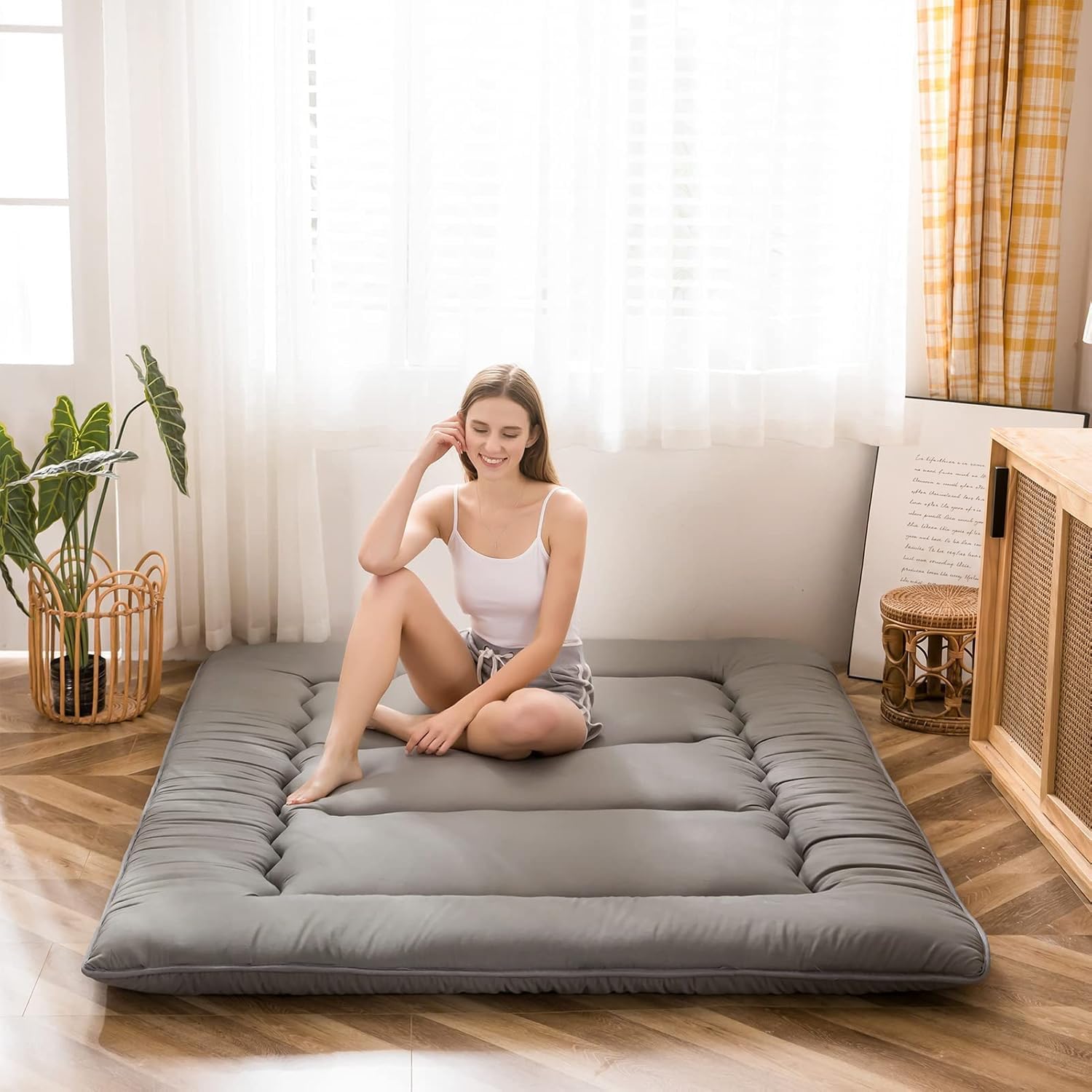 MAXYOYO Japanese floor mattress folded for portability and storage.