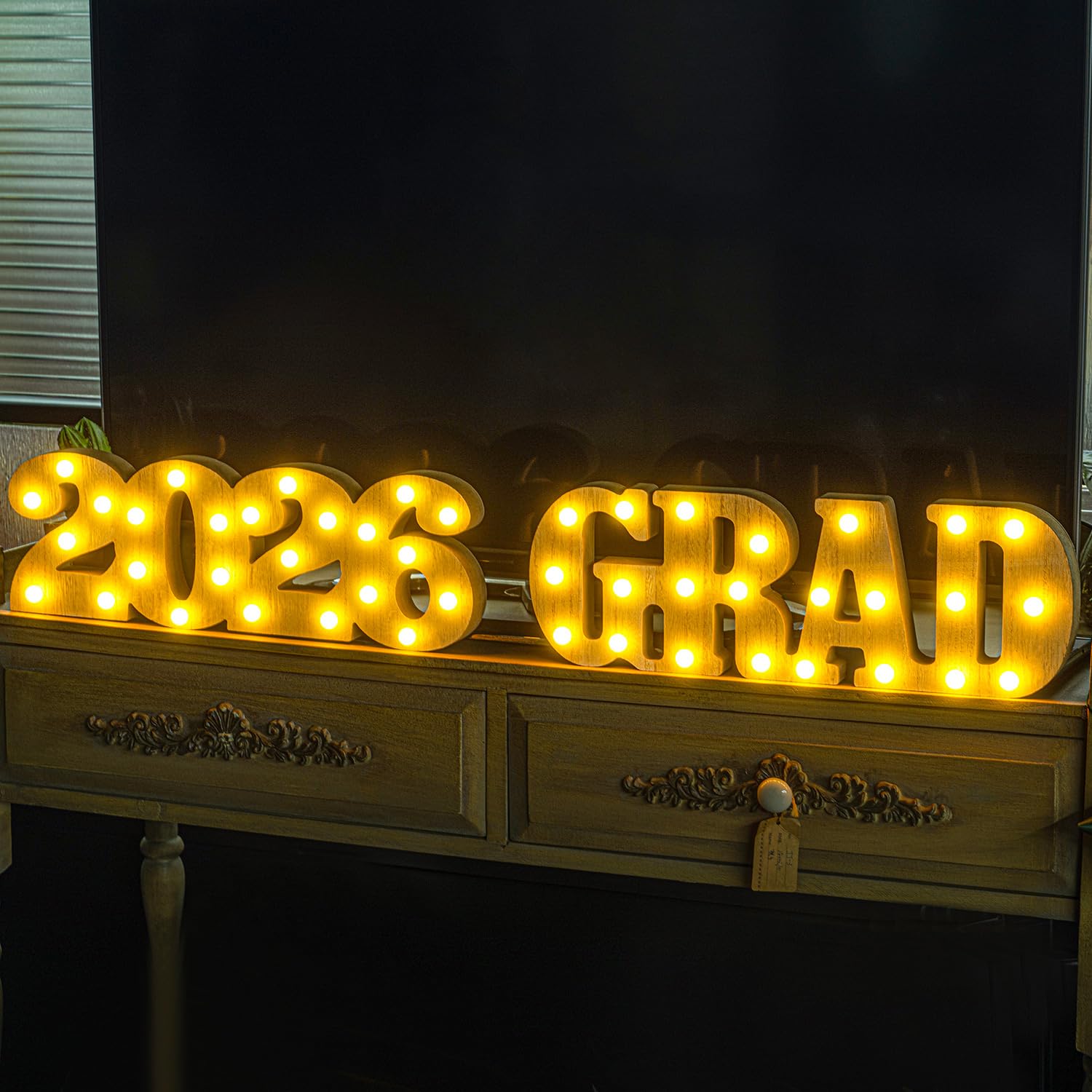 Meadin Grad 2026 LED letters stand on a podium for collegiate celebrations