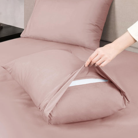 Dusty pink bed sheet set shown folded and packaged for easy gifting.