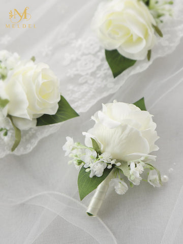 Meldel boutonniere with greenery leaves adds elegant color to formal outfits.
