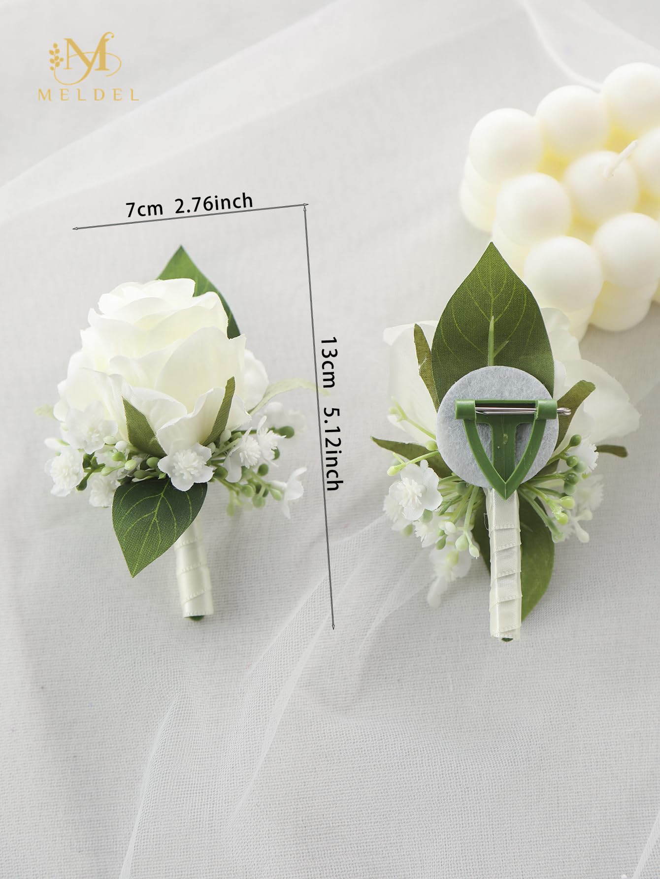 Meldel wedding boutonniere for groomsmen elevates attire with timeless white blooms.