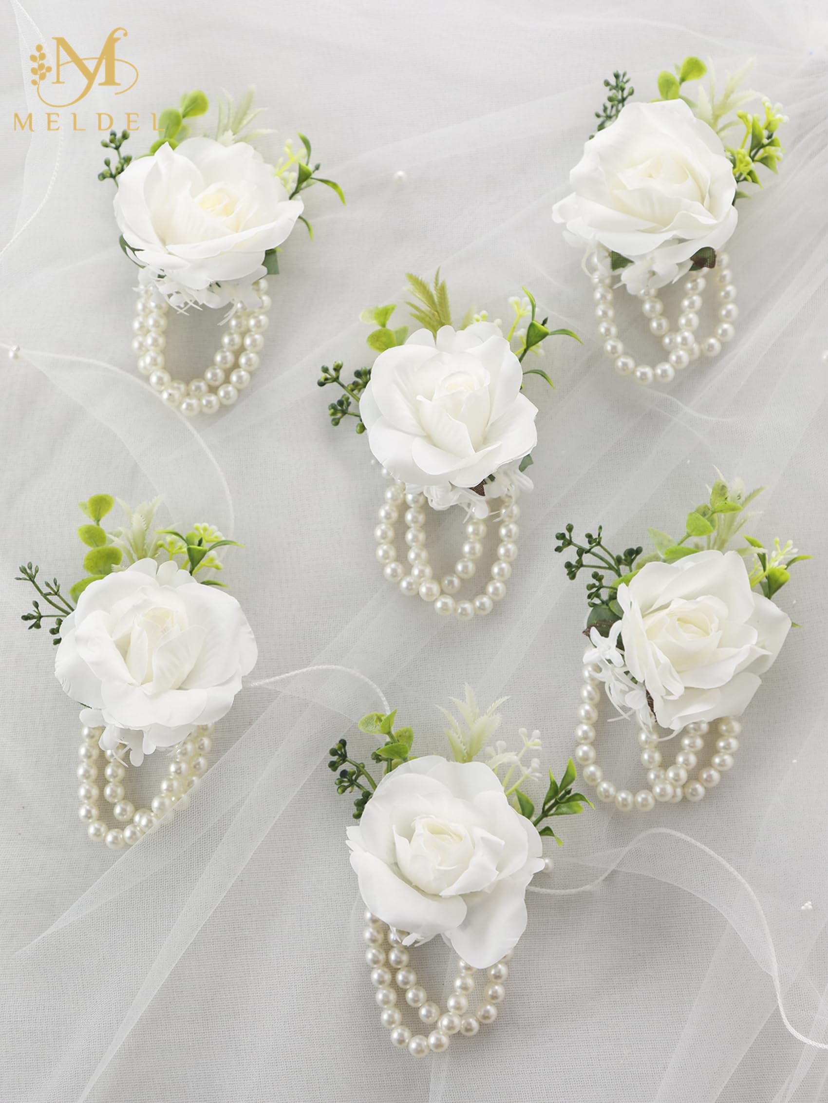 Meldel wedding corsage on bridesmaid detail suggesting coordinated party styling