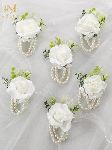 Meldel wedding corsage on bridesmaid detail suggesting coordinated party styling