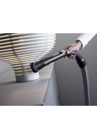 Miele Dusting Brush attaches seamlessly to canister handles for simple setup