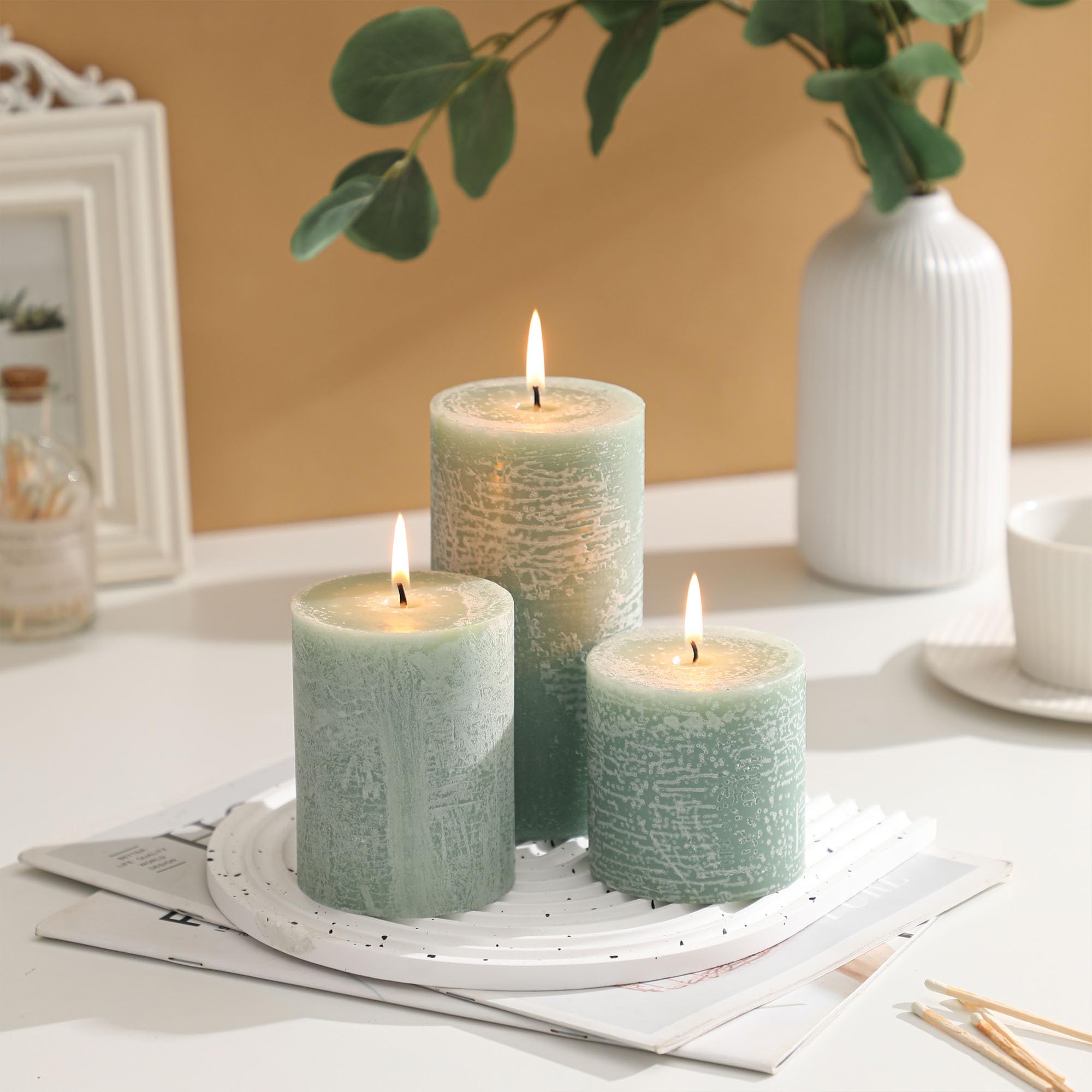 MIRASCENTS Sage Green Pillar Candles on a mantel add cozy, long-lasting light.