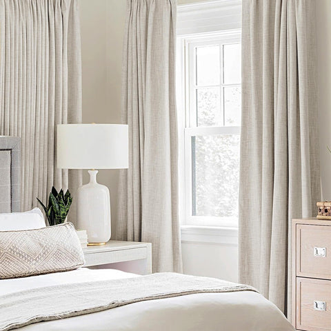 MIULEE birch blackout curtains hanging on rod to create deeper daytime darkness.