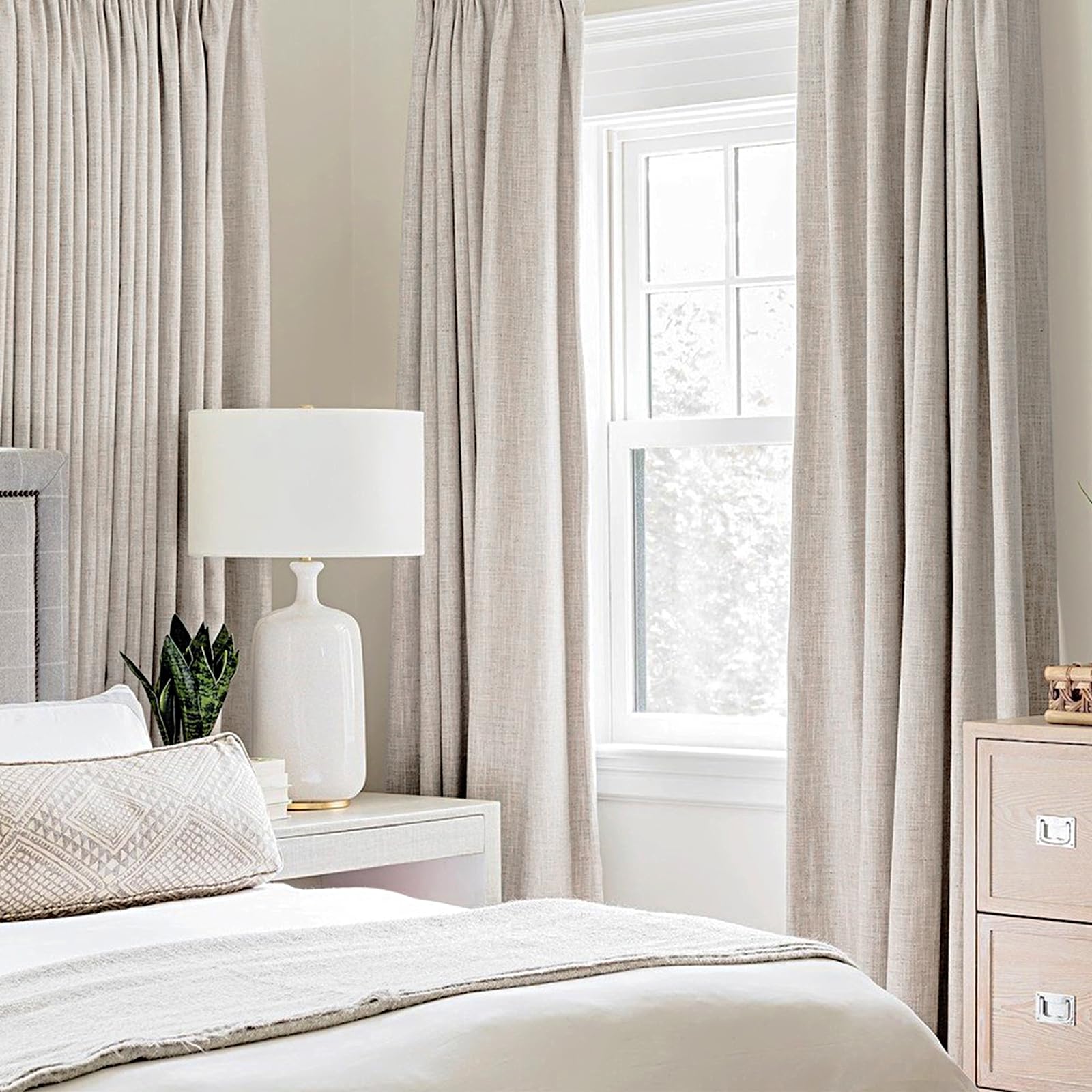 MIULEE 52x90 ivory blackout curtains hung, offering privacy and light control.