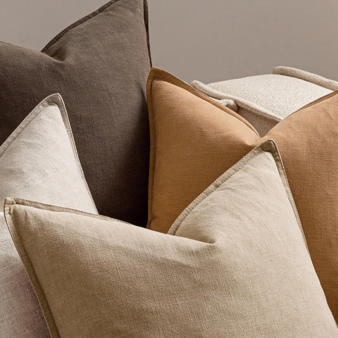 MIULEE 4-pack pillow covers arranged with greenery to illustrate coordinated living room accents.