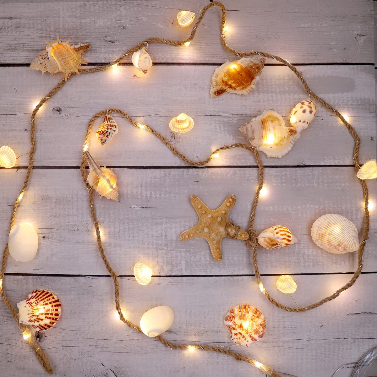 MIYA LIFE seashell garland with ocean light provides warm coastal ambiance for any room.
