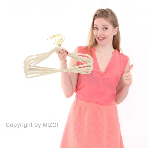 MIZGI slimline velvet hangers in ivory maintain fabric integrity while saving space.