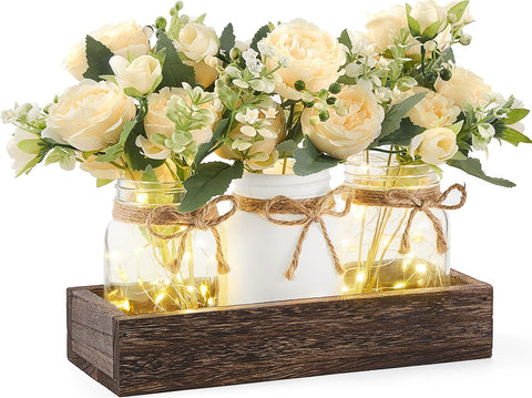 Mkono mason jar lights centerpiece on wooden box for warm dining table ambiance.