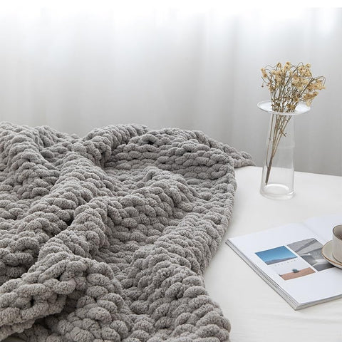 MocaDng soft cozy throw decorating a sofa in gray