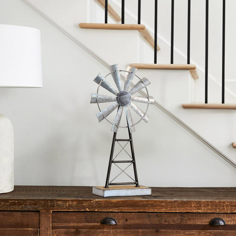 Mode Home windmill base detail highlights rustic wood and metal.