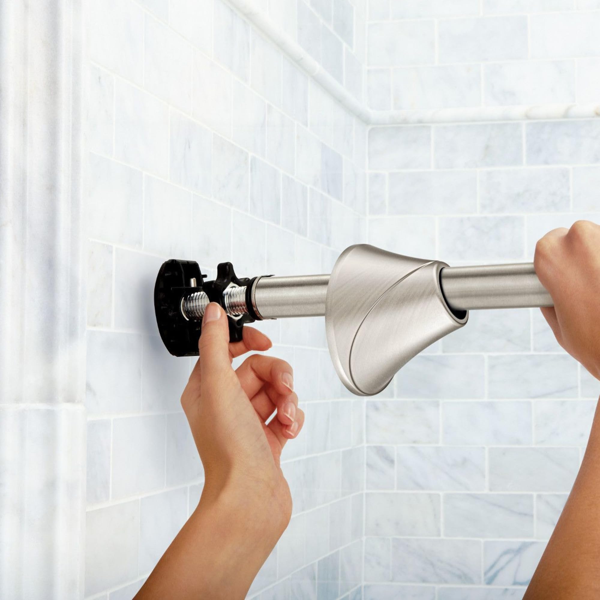 Moen curved rod in brushed nickel adds warm, modern bathroom style.