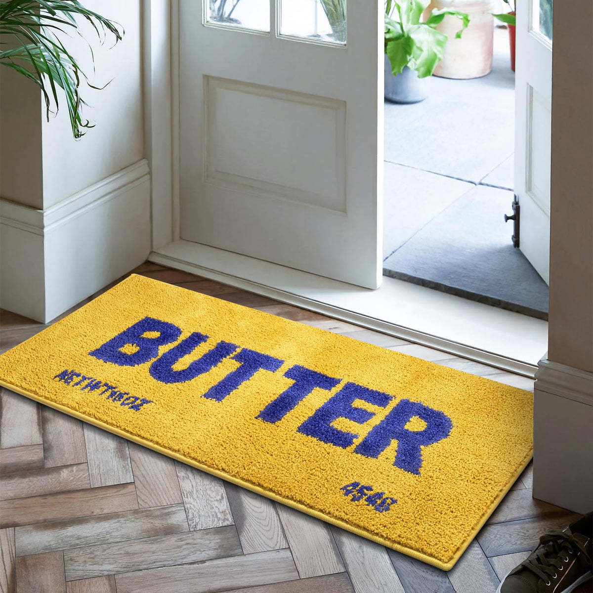 Momlli Butter Rug front view in vibrant yellow plush for warm kitchen floors.