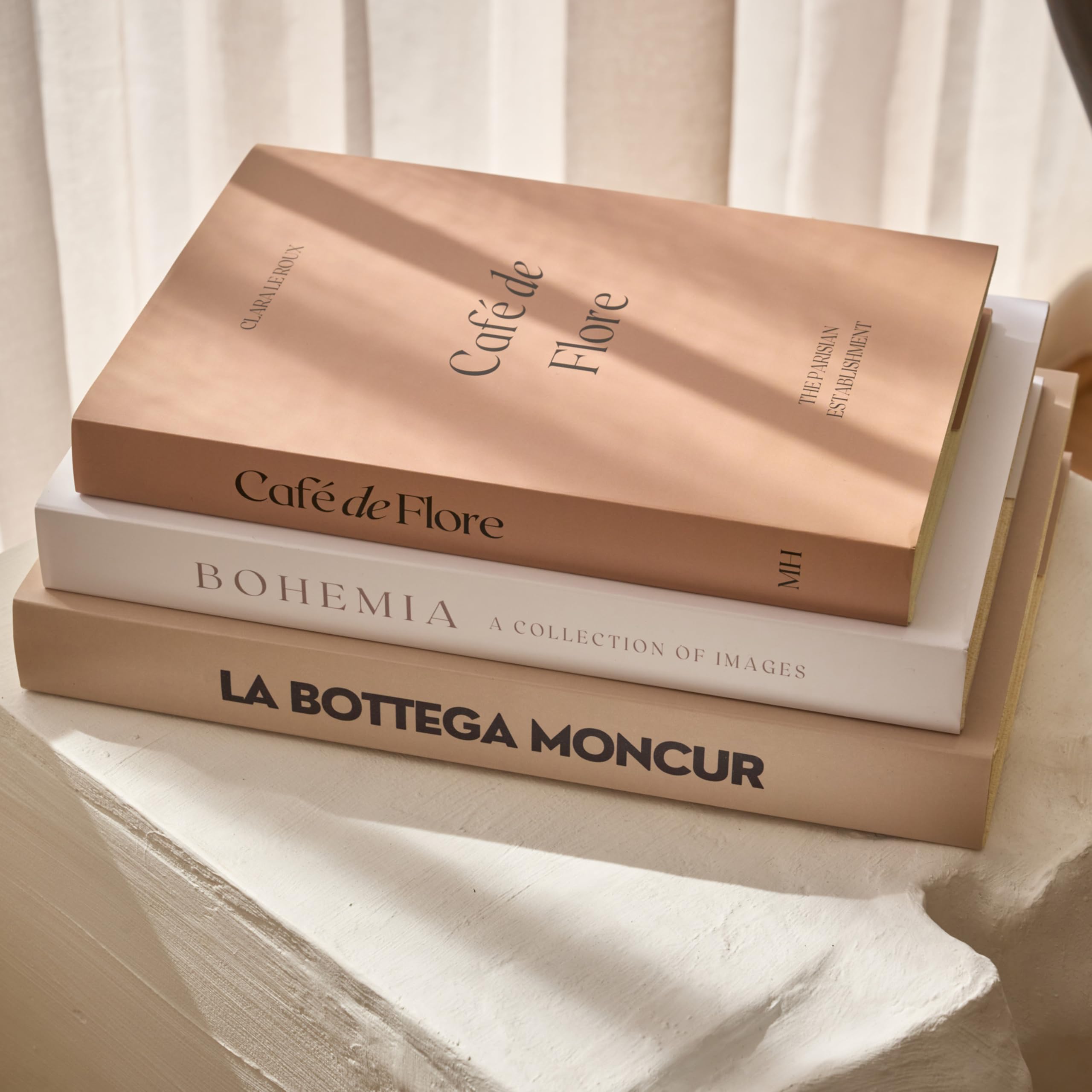 Moncur Home faux books on a coffee table stack add neutral, stylish texture.