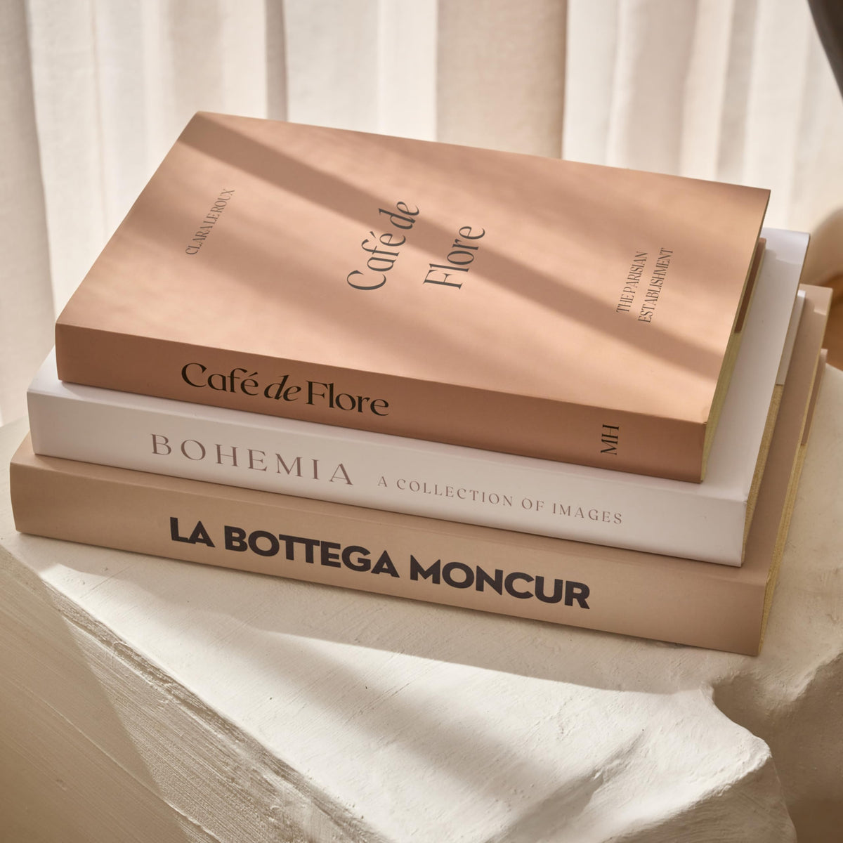 Moncur Home faux books on a coffee table stack add neutral, stylish texture.