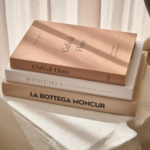 Moncur Home faux books on a coffee table stack add neutral, stylish texture.