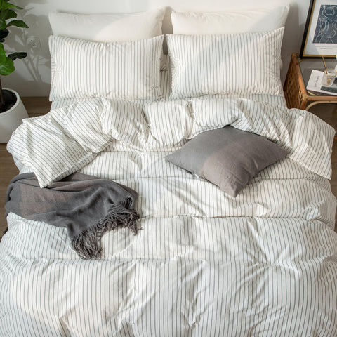 MooMee cozy bedroom scene featuring striped bedding and modern styling.