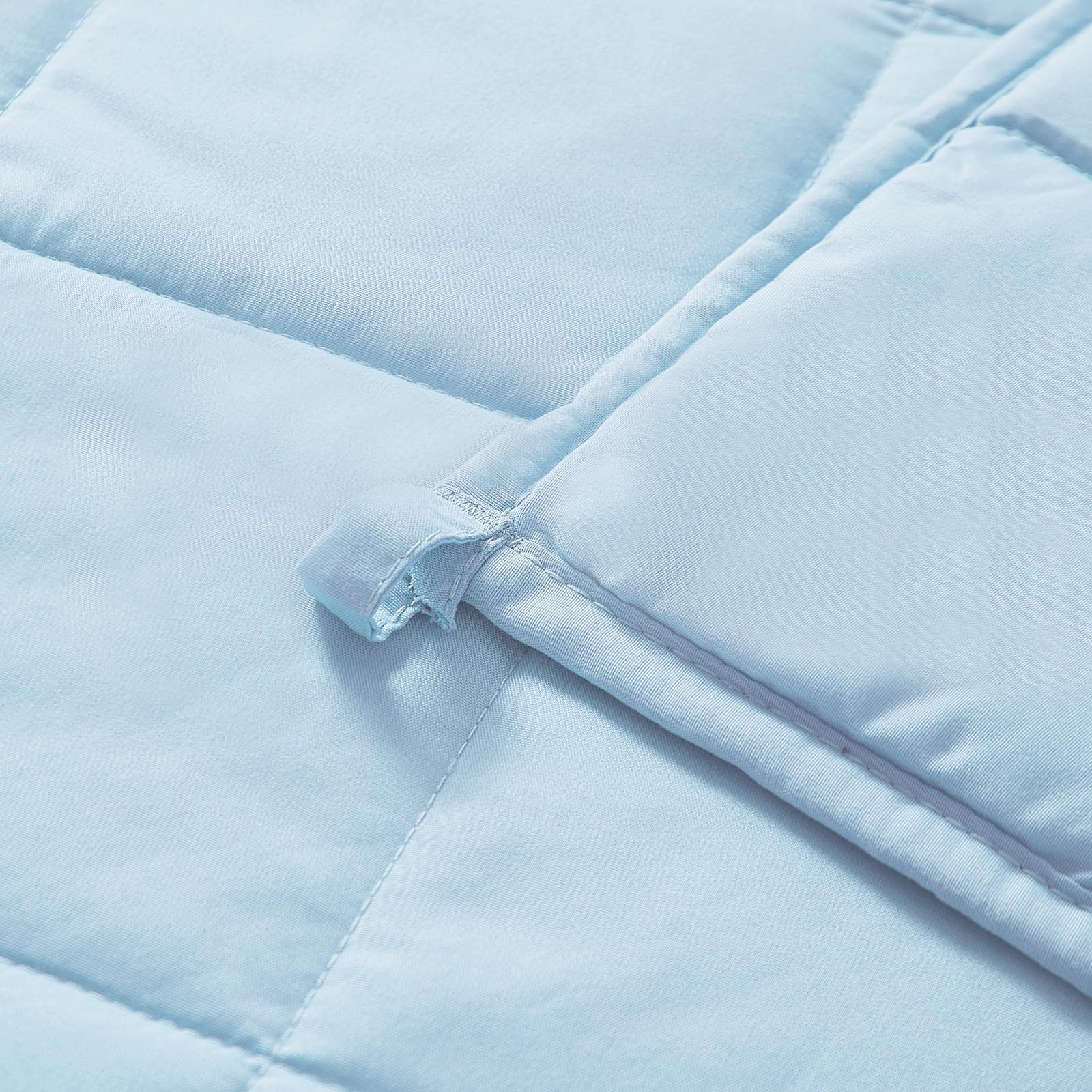 MOTRIP weighted blanket blue on bed showing generous coverage for restful nights