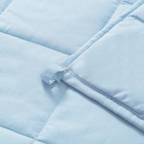 MOTRIP weighted blanket blue on bed showing generous coverage for restful nights