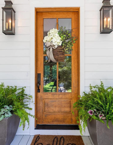MYELJO Rattan hanging basket with burlap bow elevates rustic decor.