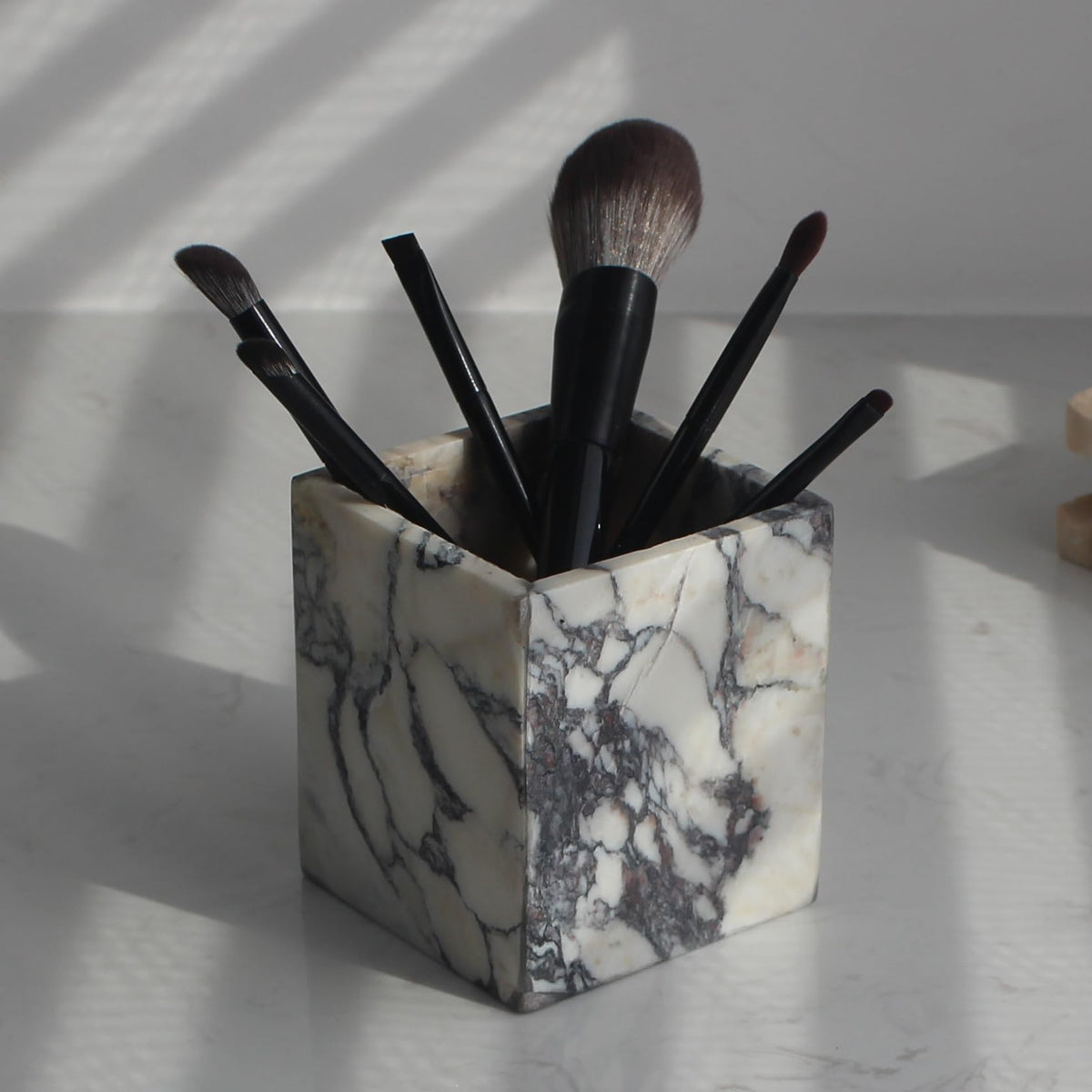 Natust Calacatta Viola toothbrush holder on bathroom counter for organized brushes