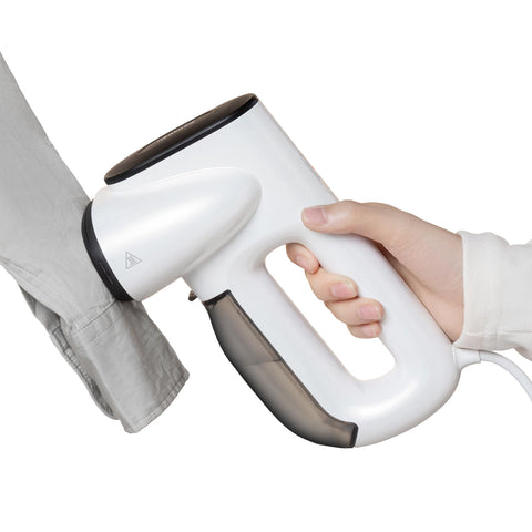 Neakasa Magic 1 front view shows compact vacuum steamer gripping fabric for safe one-handed use