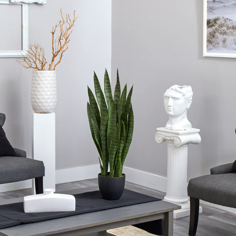 Nearly Natural snake plant display enriches living room ambiance.