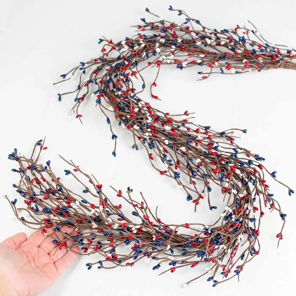 NeoL'artes pip berry stems showing red, white, and blue hues for rustic holiday accents.
