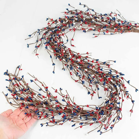 NeoL'artes pip berry stems showing red, white, and blue hues for rustic holiday accents.