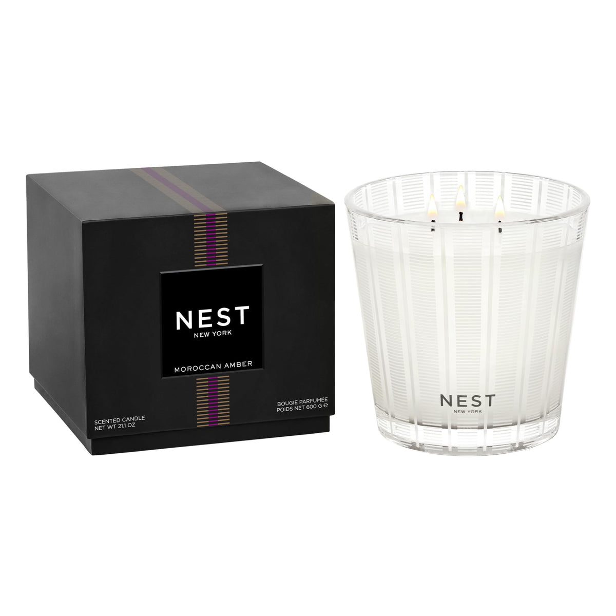 Nest New York Moroccan Amber 3-Wick Candle in a frosted striped glass jar for elegant decor.