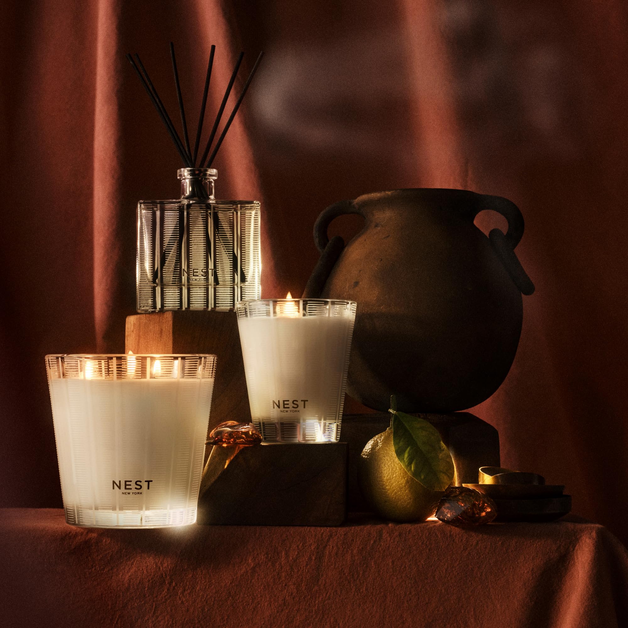 Aromas hint from Moroccan Amber and patchouli visible around the candle.