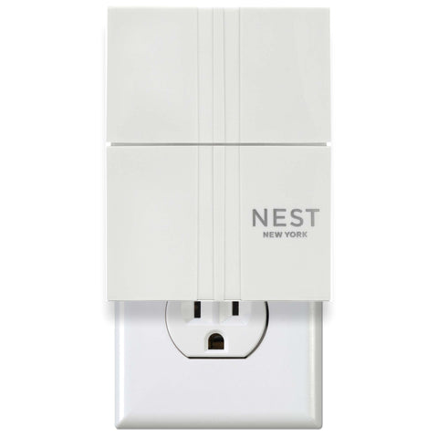 Nest New York wall diffuser plugged in at outlet for continuous fragrance throughout rooms.