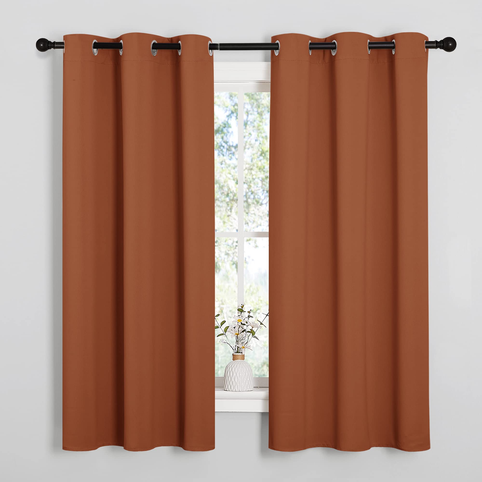 NICETOWN burnt orange curtains close-up showing triple-weave blackout fabric.