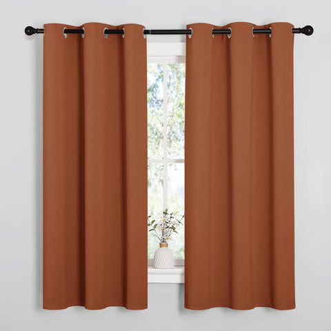 NICETOWN burnt orange curtains close-up showing triple-weave blackout fabric.