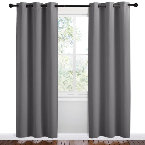 NICETOWN grey blackout curtain panel showing wide drape texture in a living room.