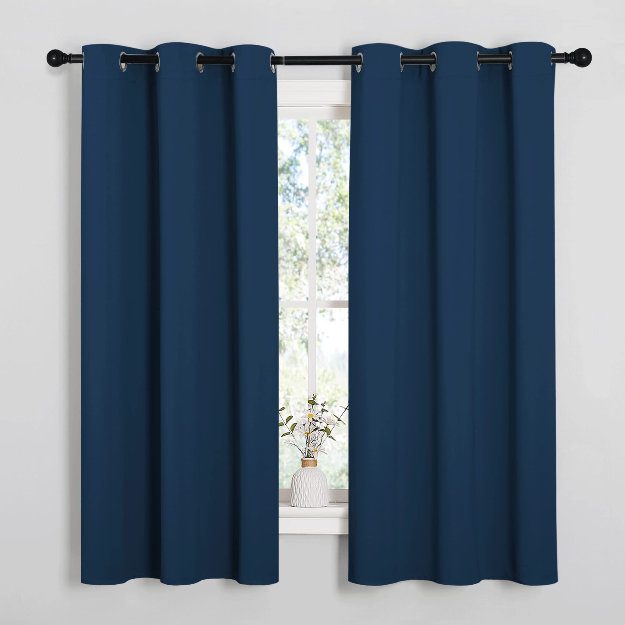 NICETOWN Moroccan blue blackout curtains block light for a calmer bedroom.