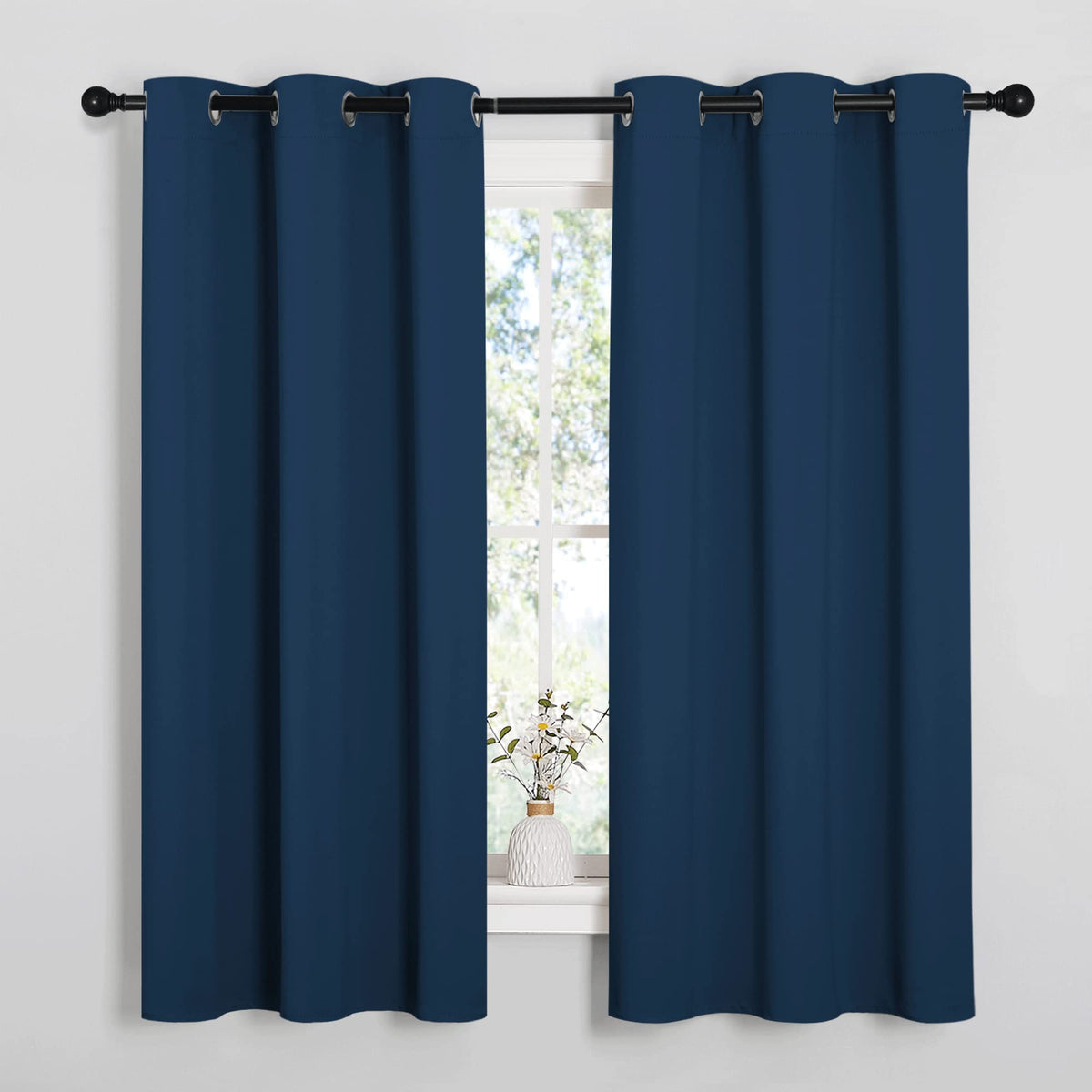 NICETOWN Moroccan blue blackout curtains block light for a calmer bedroom.