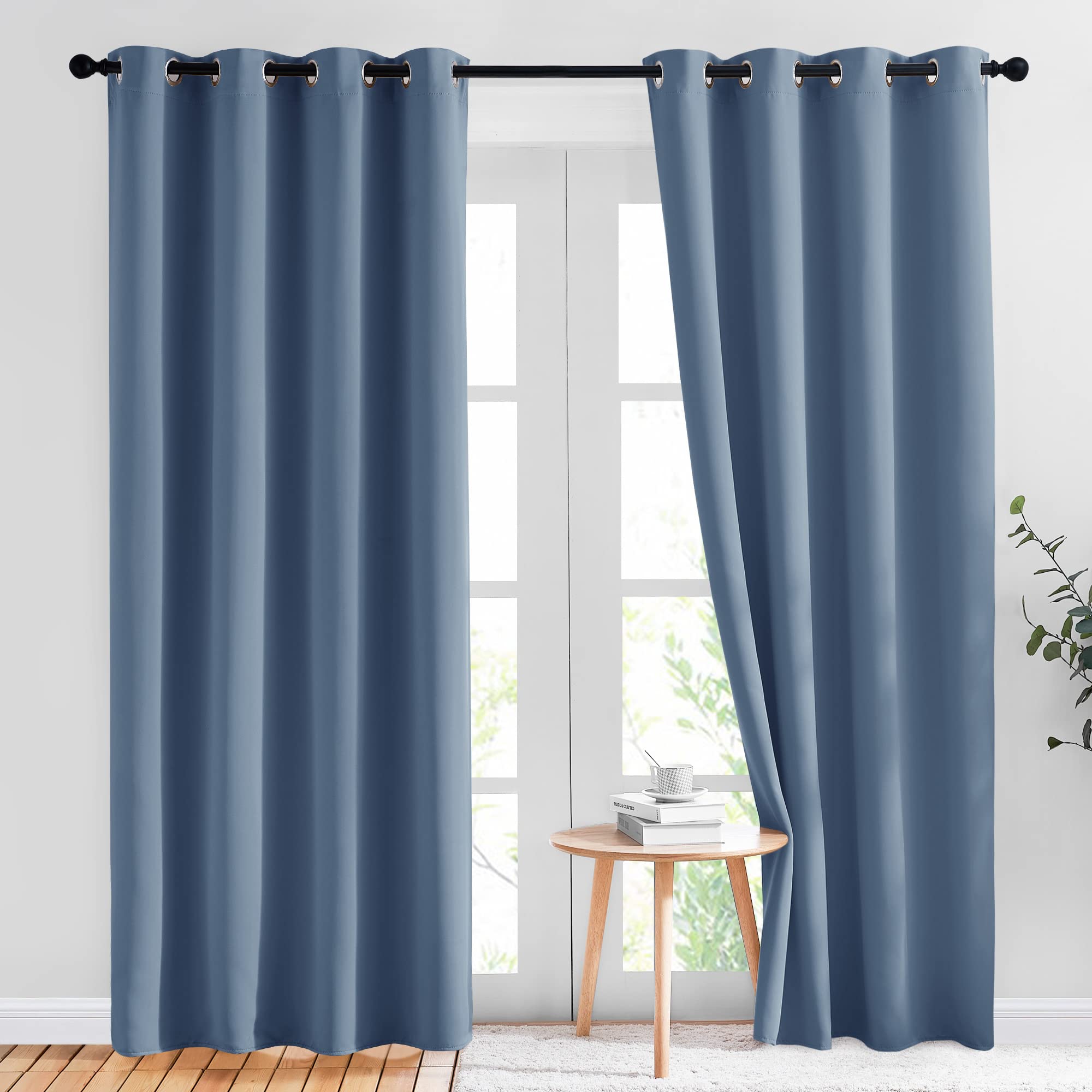 NICETOWN Stone Blue blackout curtain on rod highlighting grommet design for easy sliding and privacy.