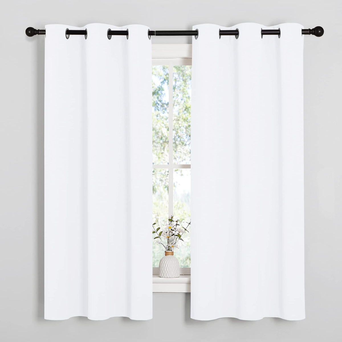 NICETOWN white curtain close-up with silver grommets for smooth sliding.
