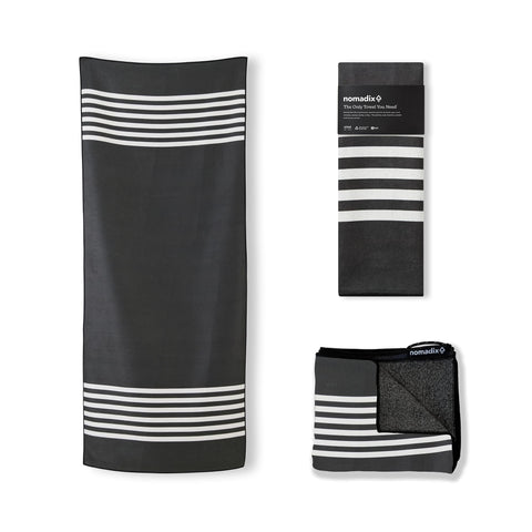 Nomadix Original Towel beach scene showing ultra-absorbent action for quick drying
