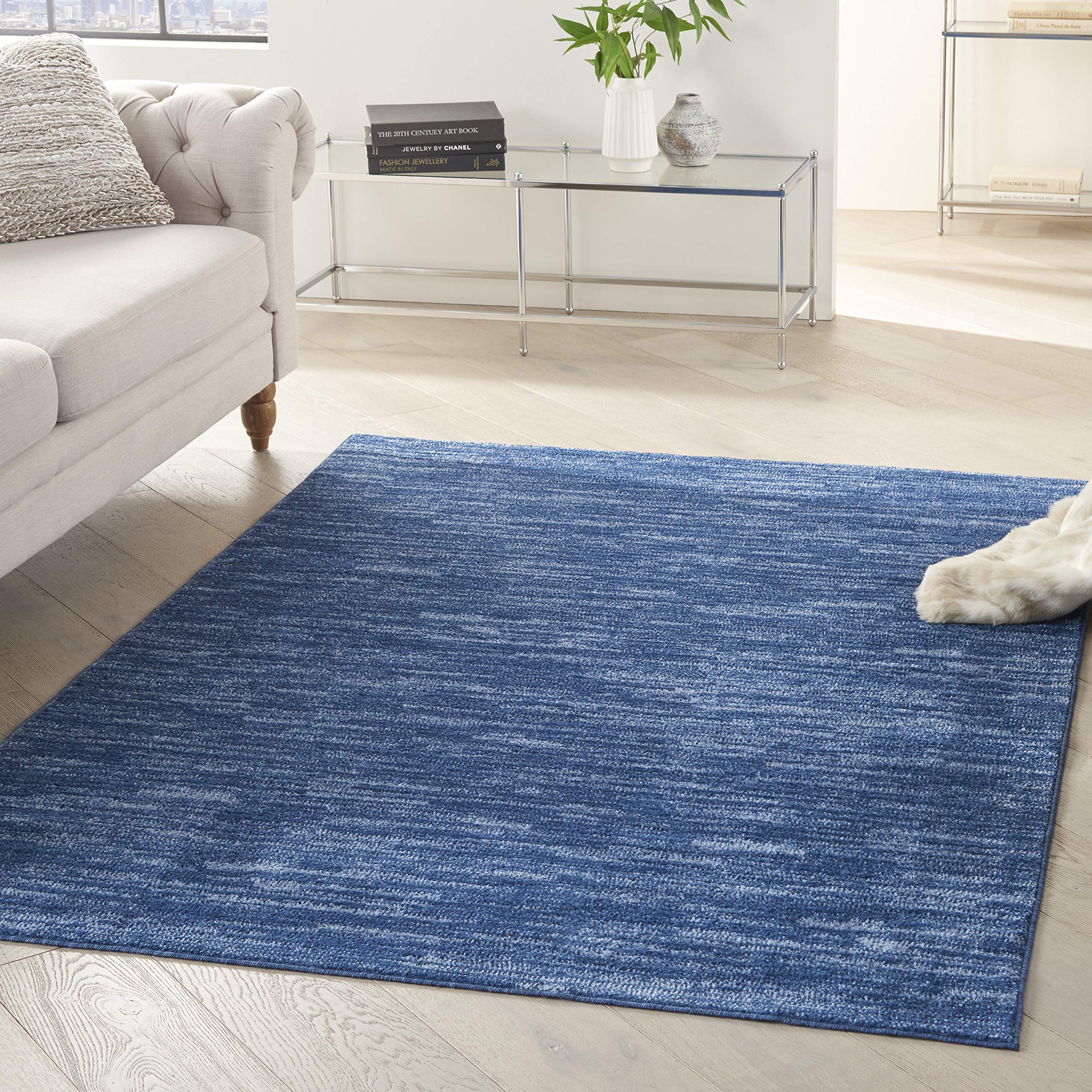 Nourison Essentials navy blue 4x6 area rug with a low-pile texture for easy placement