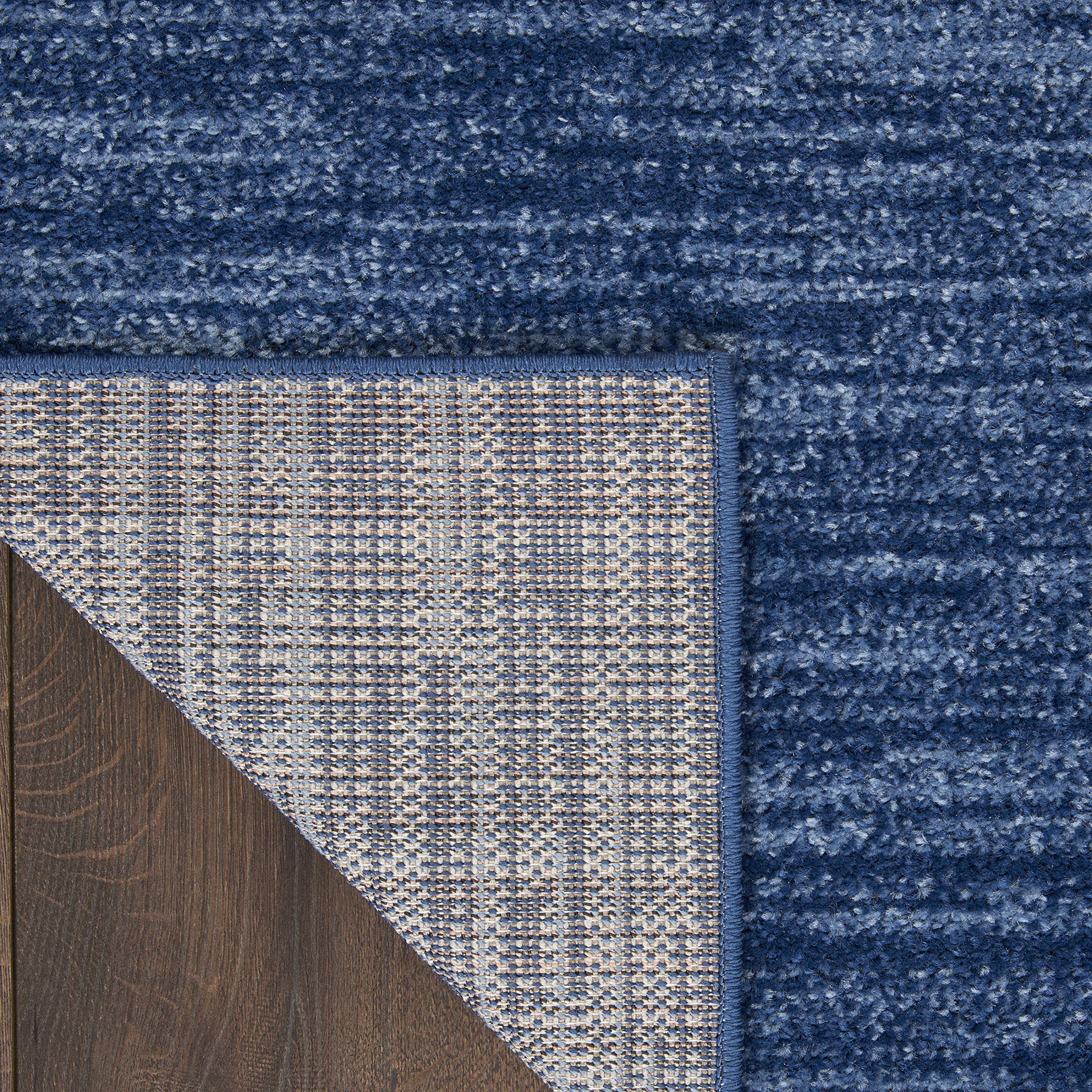 Nourison Essentials navy blue rug offers a soft hand feel underfoot