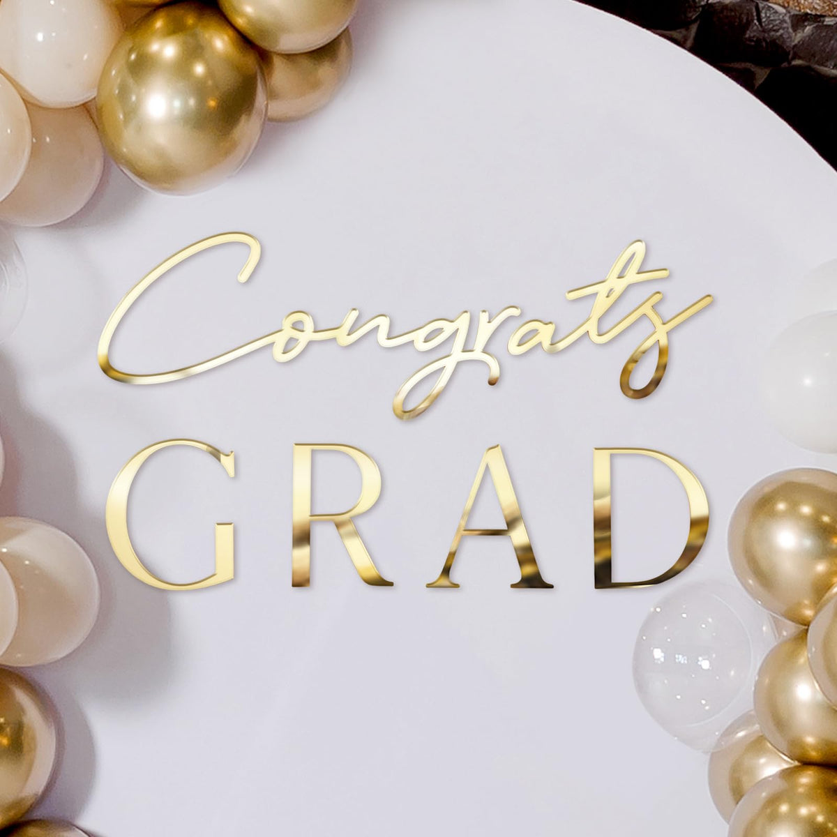 Novabright Congrats Grad Sign backdrop in gold acrylic mirrors for elegant graduation photos.